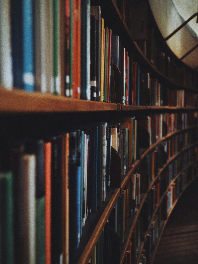 pexels photo 3646105 3646105 Warm-toned image of curved library bookshelves filled with books in Stockholm.